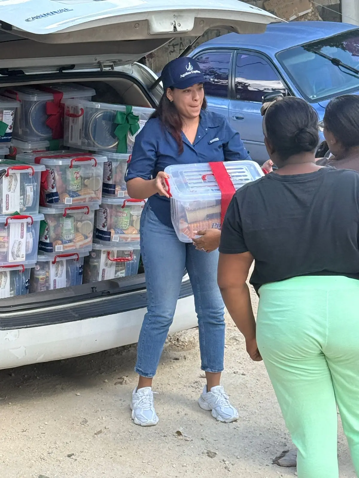 Agallas Cares volunteer distributing food baskets to local families